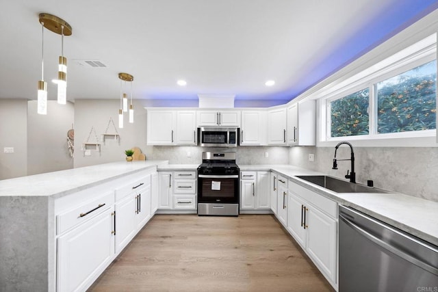 13824 Powers Rd, Poway, CA 92064 - kitchen with appliances with stainless steel finishes, a sink, a peninsula, decorative backsplash, and recessed lighting