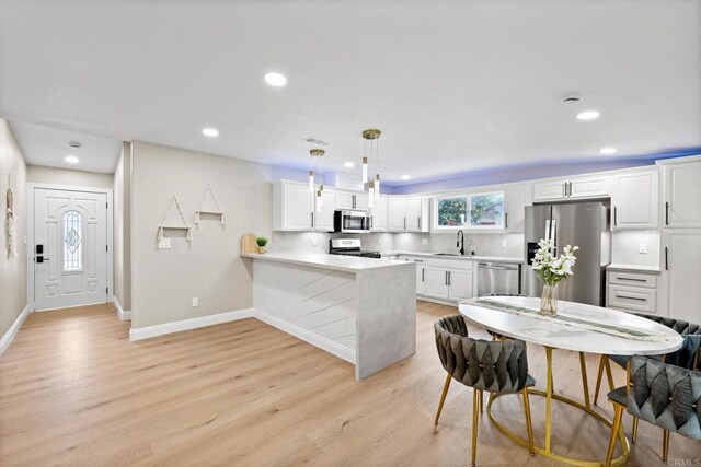 13824 Powers Rd, Poway, CA 92064 - kitchen with appliances with stainless steel finishes, a sink, light wood-style flooring, baseboards, and recessed lighting