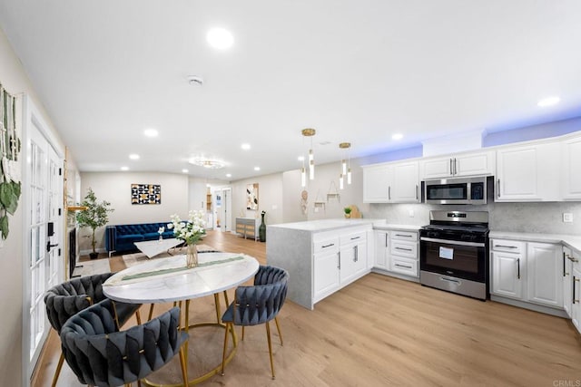 13824 Powers Rd, Poway, CA 92064 - kitchen with stainless steel appliances, a peninsula, recessed lighting, light countertops, and light wood finished floors
