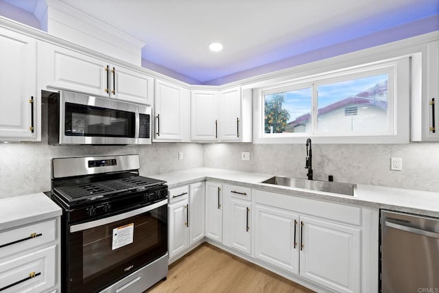 13824 Powers Rd, Poway, CA 92064 - kitchen with appliances with stainless steel finishes, a sink, light countertops, white cabinetry, and recessed lighting