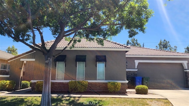 10372 Christo Way, Elk Grove, CA 95757 - ranch-style home featuring a tiled roof, stone siding, an attached garage, concrete driveway, and stucco siding