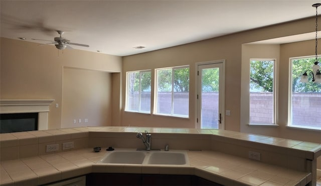 10372 Christo Way, Elk Grove, CA 95757 - kitchen featuring a sink, healthy amount of natural light, tile counters, and a ceiling fan