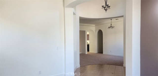 10372 Christo Way, Elk Grove, CA 95757 - hallway featuring light carpet, a chandelier, arched walkways, baseboards, and light tile patterned flooring