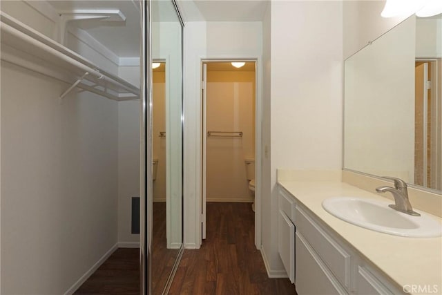2150 Cheyenne Way Unit 165, Fullerton, CA 92833 - bathroom with toilet, vanity, wood finished floors, and baseboards