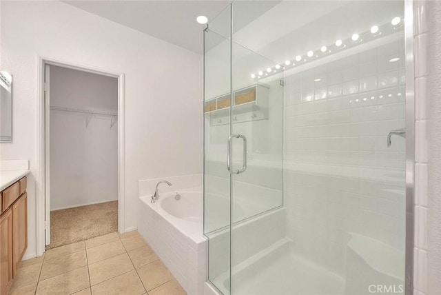 1080 Athens Way, Upland, CA 91786 - bathroom with tile patterned floors, a shower stall, vanity, a walk in closet, and a bath