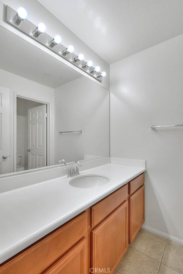 1080 Athens Way, Upland, CA 91786 - bathroom featuring vanity, tile patterned floors, baseboards, and toilet