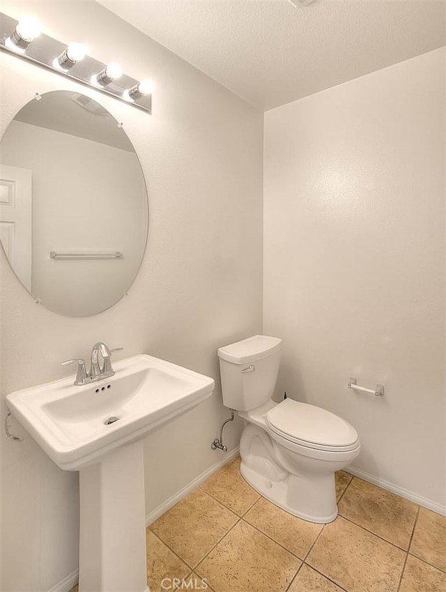 1080 Athens Way, Upland, CA 91786 - bathroom with toilet, tile patterned flooring, a textured ceiling, baseboards, and a sink