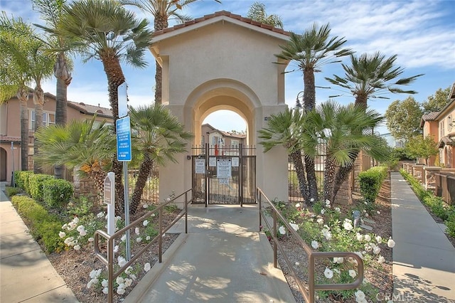 1080 Athens Way, Upland, CA 91786 - doorway to property with stucco siding and a gate