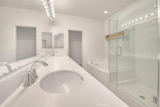 1080 Athens Way, Upland, CA 91786 - bathroom featuring a shower stall, a walk in closet, a bath, double vanity, and recessed lighting
