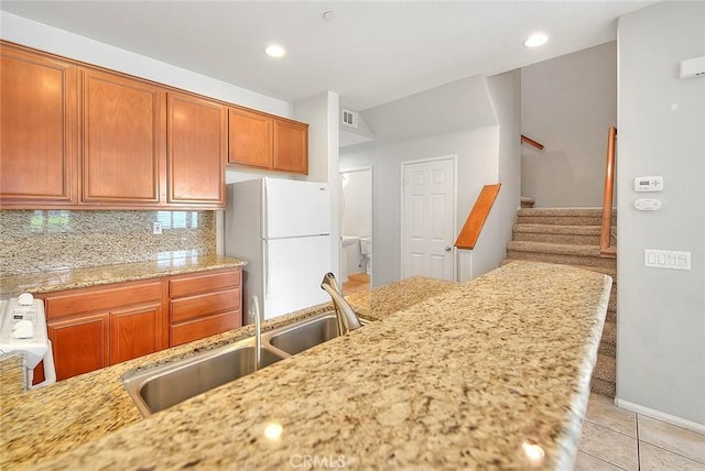 1080 Athens Way, Upland, CA 91786 - kitchen with freestanding refrigerator, a sink, brown cabinets, light stone counters, and recessed lighting