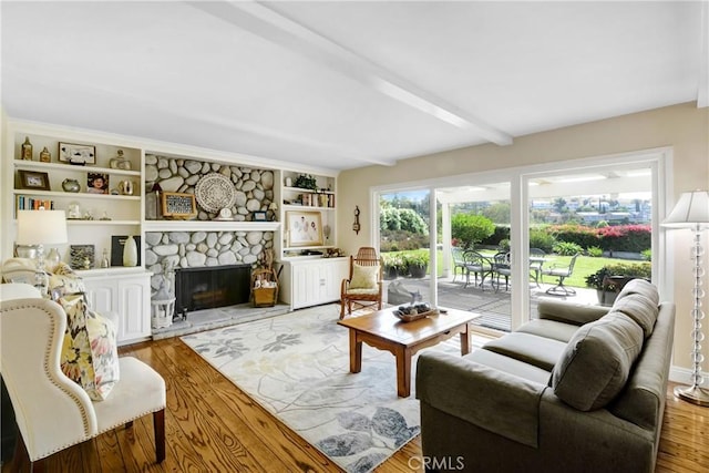 8640 Lindante Dr, Whittier, CA 90603 - living room with light wood-type flooring, a stone fireplace, and beam ceiling