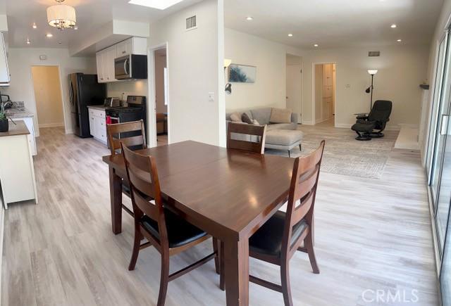 11529 De Celis Pl, Granada Hills, CA 91344 - dining area with light wood-style flooring, a chandelier, recessed lighting, and baseboards