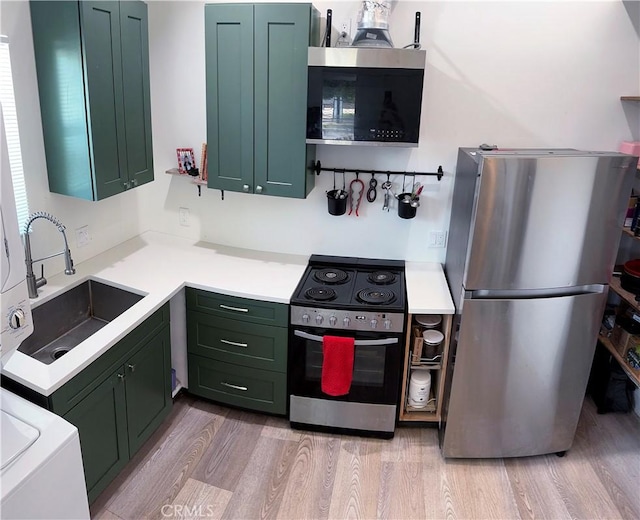 11529 De Celis Pl, Granada Hills, CA 91344 - kitchen with stainless steel appliances, green cabinetry, and light wood-style flooring