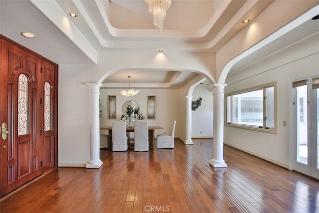 3624 Hollins Ave, Claremont, CA 91711 - entrance foyer featuring ornate columns, a raised ceiling, arched walkways, a chandelier, and plenty of natural light