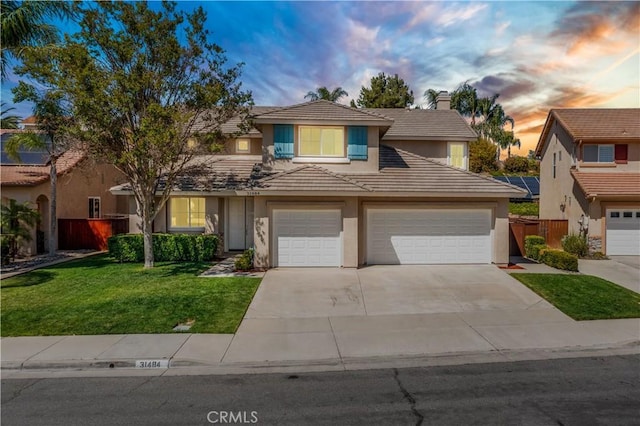 31484 Britton Cir, Temecula, CA 92591 - traditional-style house with stucco siding, a tile roof, driveway, a chimney, and an attached garage