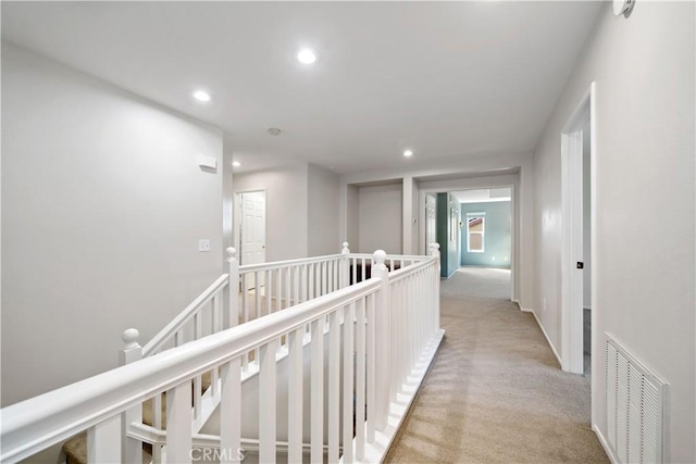 31484 Britton Cir, Temecula, CA 92591 - hallway with recessed lighting, light carpet, and an upstairs landing