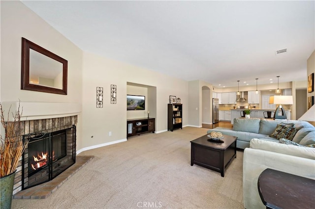 31484 Britton Cir, Temecula, CA 92591 - living area featuring a fireplace, light carpet, baseboards, arched walkways, and recessed lighting