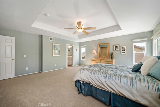 31484 Britton Cir, Temecula, CA 92591 - carpeted bedroom with a tray ceiling, baseboards, ensuite bathroom, and a ceiling fan
