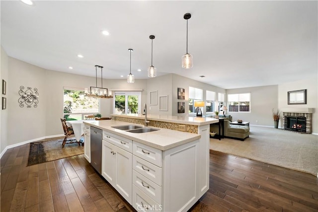 31484 Britton Cir, Temecula, CA 92591 - kitchen featuring a sink, stainless steel dishwasher, a kitchen island with sink, light countertops, and baseboards