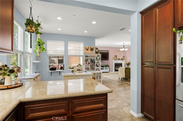 3245 Moss Landing Blvd, Oxnard, CA 93036 - kitchen with recessed lighting, light stone countertops, light tile patterned floors, a peninsula, and open floor plan