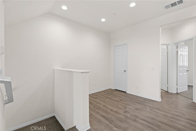 14856 Maple Ter, Panorama City, CA 91402 - empty room with recessed lighting, baseboards, wood finished floors, and vaulted ceiling