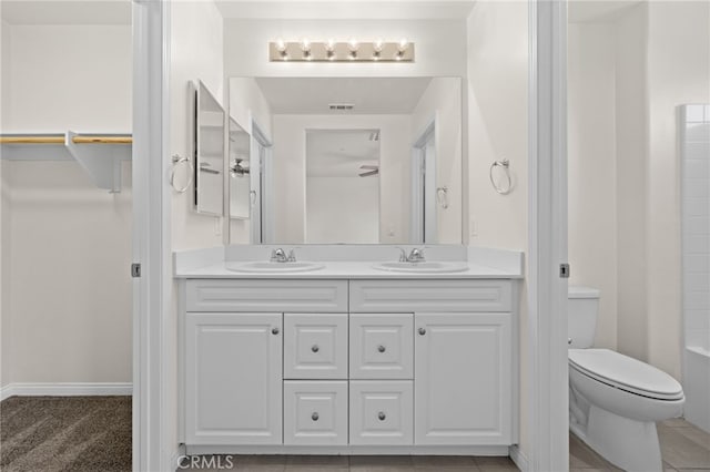 14856 Maple Ter, Panorama City, CA 91402 - full bathroom with double vanity, toilet, and baseboards