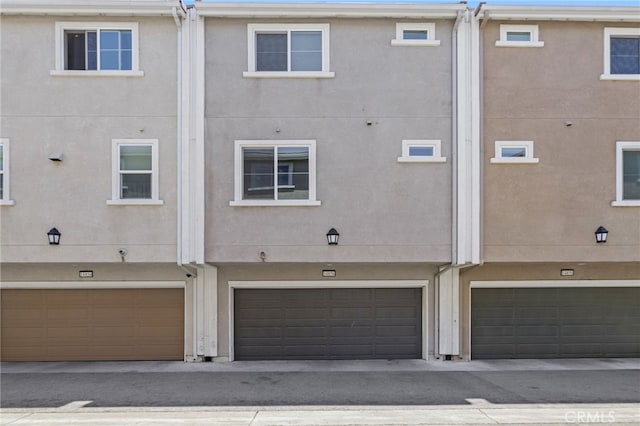 14856 Maple Ter, Panorama City, CA 91402 - back of house featuring a garage and stucco siding