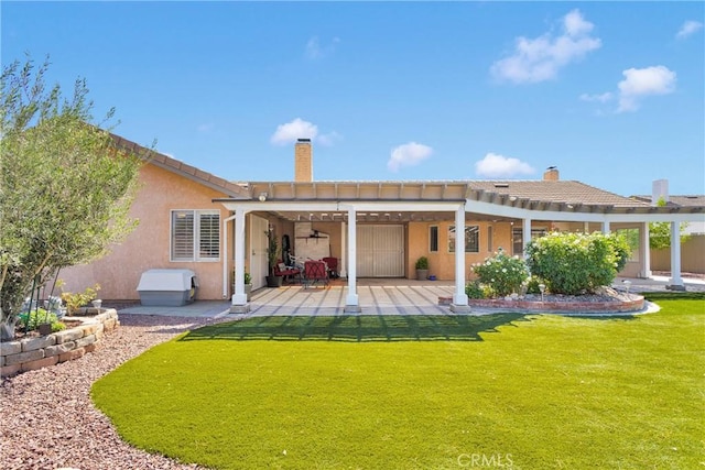 13950 High Falls Trl, Apple Valley, CA 92307 - rear view of house featuring a pergola, stucco siding, a lawn, a patio area, and a chimney