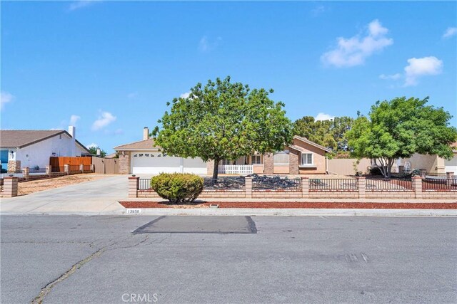 13950 High Falls Trl, Apple Valley, CA 92307 - obstructed view of property with driveway, a fenced front yard, and an attached garage