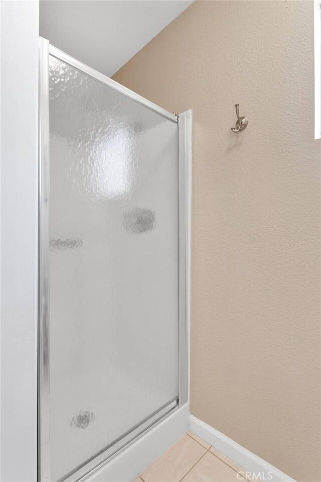 13950 High Falls Trl, Apple Valley, CA 92307 - full bath featuring tile patterned floors, a stall shower, and baseboards