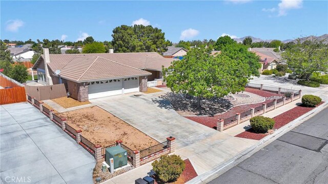 13950 High Falls Trl, Apple Valley, CA 92307 - ranch-style house with a tile roof, a garage, concrete driveway, a residential view, and a chimney