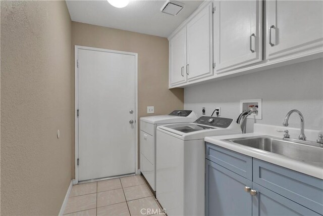 13950 High Falls Trl, Apple Valley, CA 92307 - washroom featuring cabinet space, washer and dryer, light tile patterned floors, and baseboards