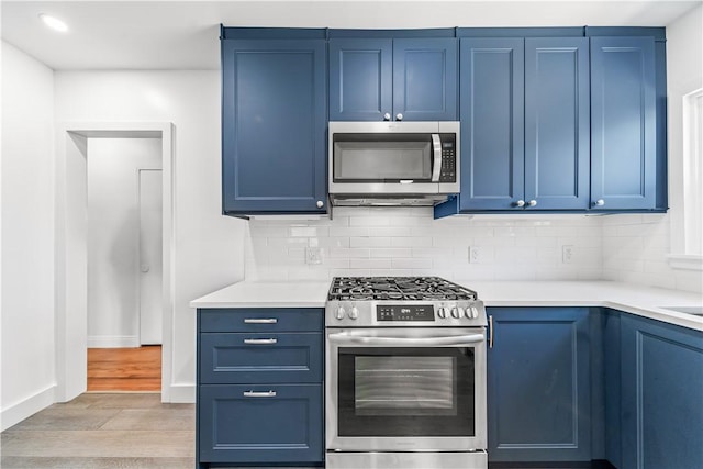 2125 256th St, Lomita, CA 90717 - kitchen featuring appliances with stainless steel finishes, blue cabinets, and light wood-style flooring