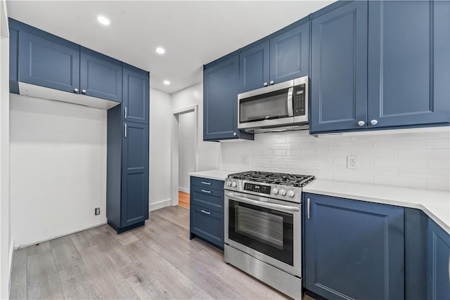 2125 256th St, Lomita, CA 90717 - kitchen with appliances with stainless steel finishes, blue cabinetry, light wood finished floors, light countertops, and recessed lighting