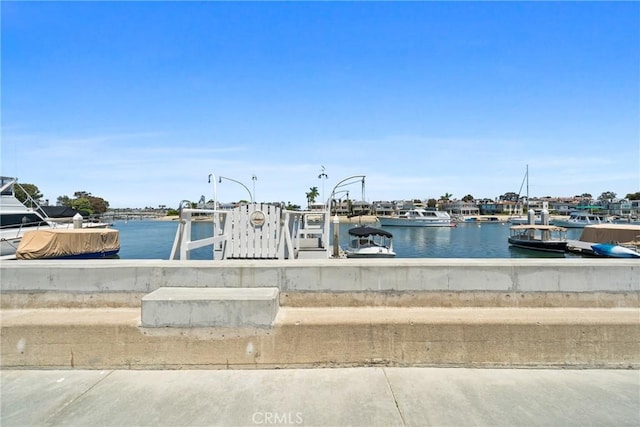129 N Bay Front, Newport Beach, CA 92662 - dock area featuring a water view and a boat ramp