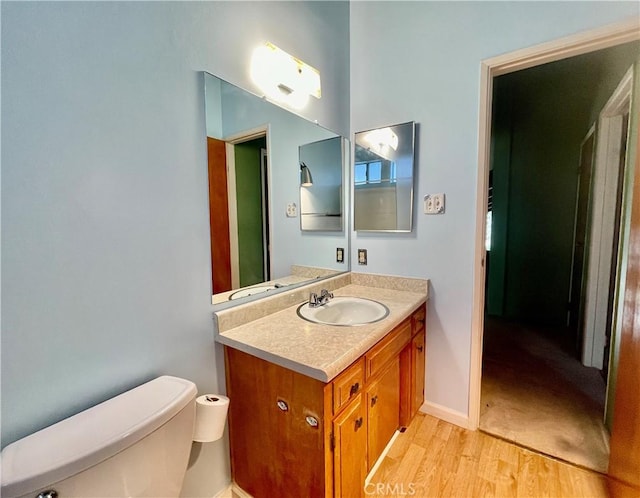 2521 Cedarwood Dr, Pine Mountain Club, CA 93222 - bathroom featuring toilet, vanity, wood finished floors, and baseboards