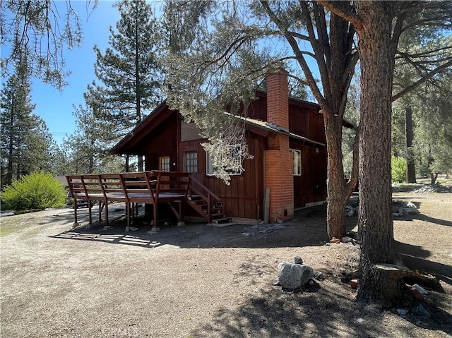 2521 Cedarwood Dr, Pine Mountain Club, CA 93222 - back of property with a deck and a chimney