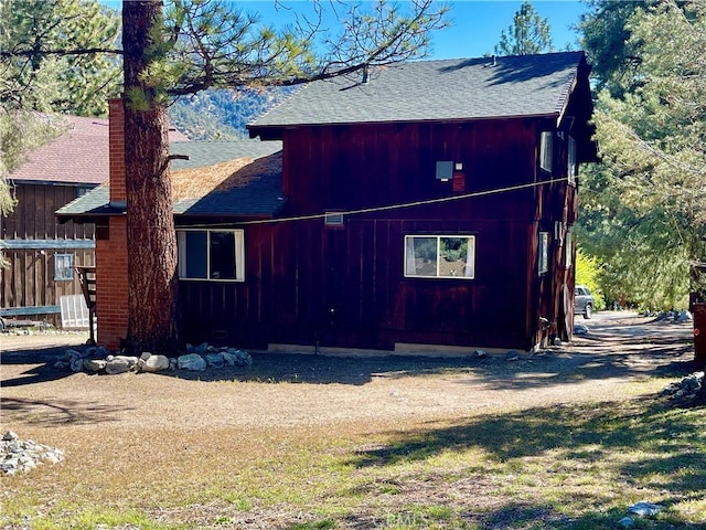 2521 Cedarwood Dr, Pine Mountain Club, CA 93222 - view of side of property with a shingled roof and a chimney