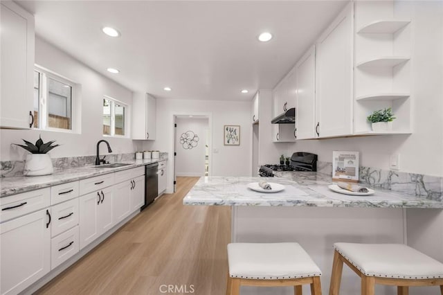 201 S Melrose St, Placentia, CA 92870 - kitchen with gas range, open shelves, under cabinet range hood, a sink, and white cabinetry