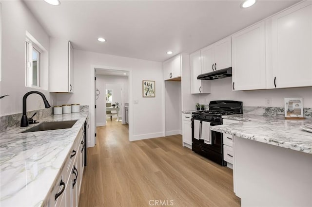 201 S Melrose St, Placentia, CA 92870 - kitchen with black range with gas stovetop, a sink, under cabinet range hood, light wood-type flooring, and recessed lighting