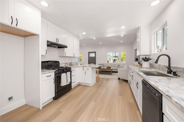 201 S Melrose St, Placentia, CA 92870 - kitchen with black range with gas stovetop, dishwasher, a sink, under cabinet range hood, and open floor plan