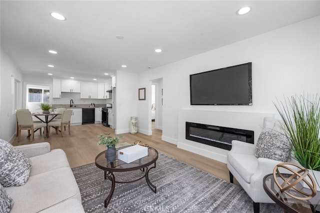 201 S Melrose St, Placentia, CA 92870 - living room with light wood-style floors, baseboards, recessed lighting, and a glass covered fireplace