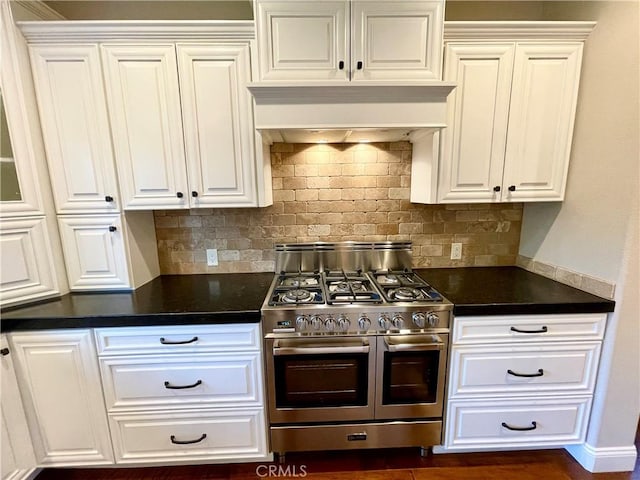 1371 Silhouette Ct, Merced, CA 95340 - kitchen with range with two ovens, dark countertops, tasteful backsplash, and white cabinetry