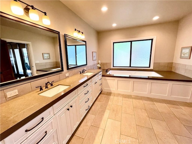 1371 Silhouette Ct, Merced, CA 95340 - bathroom with healthy amount of natural light, double vanity, recessed lighting, a bath, and tile patterned floors