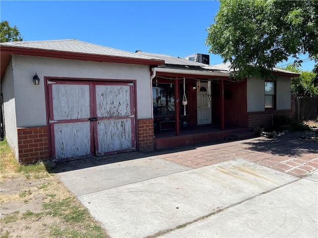 1681 Winton Way, Atwater, CA 95301 - back of house with brick siding, roof mounted solar panels, a porch, and stucco siding