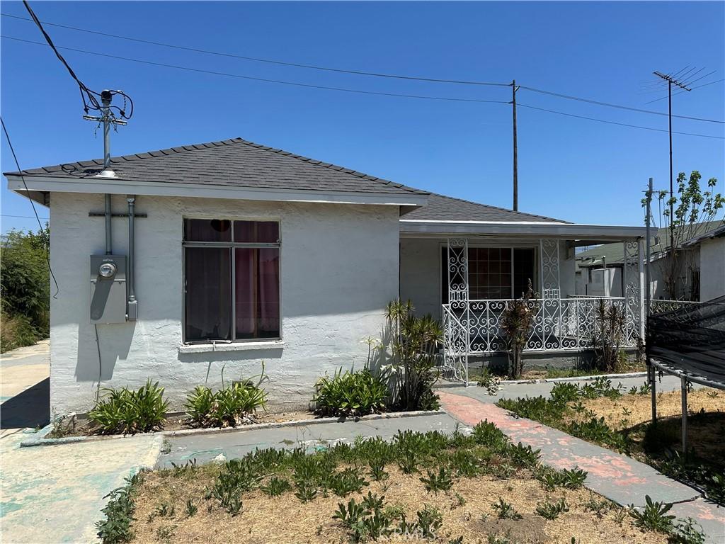 725 W K St, Colton, CA 92324 - view of front of home featuring a porch, stucco siding, and a shingled roof