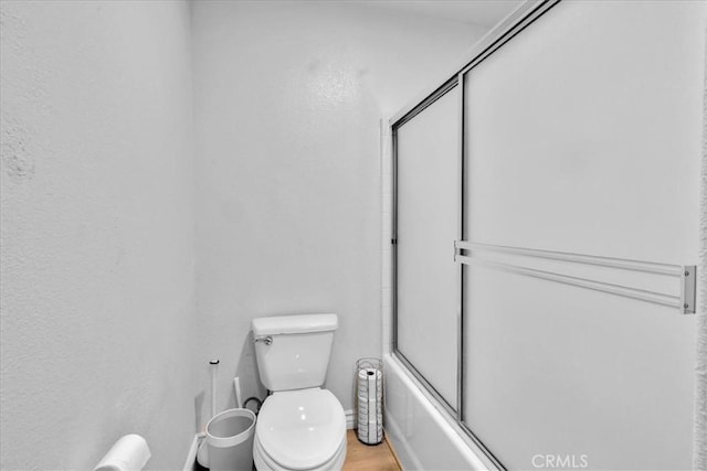 5947 Lupine Ave Unit 29, Palms, CA 92277 - bathroom with toilet, shower / bath combination with glass door, and baseboards