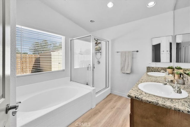 5947 Lupine Ave Unit 29, Palms, CA 92277 - full bathroom with a garden tub, plenty of natural light, double vanity, a stall shower, and vaulted ceiling