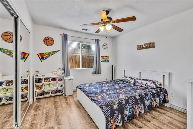 5947 Lupine Ave Unit 29, Palms, CA 92277 - bedroom featuring light wood-style flooring, a closet, and a ceiling fan
