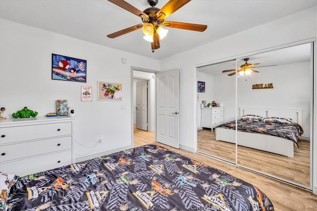 5947 Lupine Ave Unit 29, Palms, CA 92277 - bedroom with light wood-style floors, a ceiling fan, and a closet